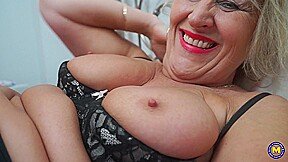 A lustful, older English woman named Misty is pleasuring herself while lying in bed.