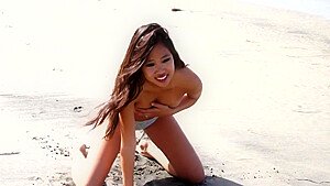 Hot Asian model Audrey in yellow bikini strips on beach