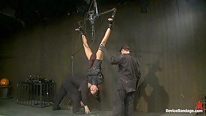 Bound in a straightjacket, inverted suspendedFucked by a machine, made to suck cock & zippered.