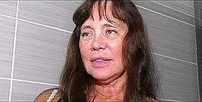 A mature woman, around sixty years old and with a robust physique, engaged in vigorous sexual activity.