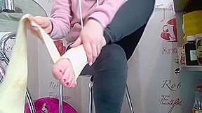 Girl sprains her ankle in high heeled knee boots on beach, bandages ankle