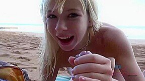 Lovely blonde with a pretty smile is having sex on the beach, with a handsome stranger